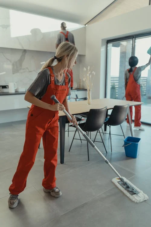 A group of people cleaning a house 