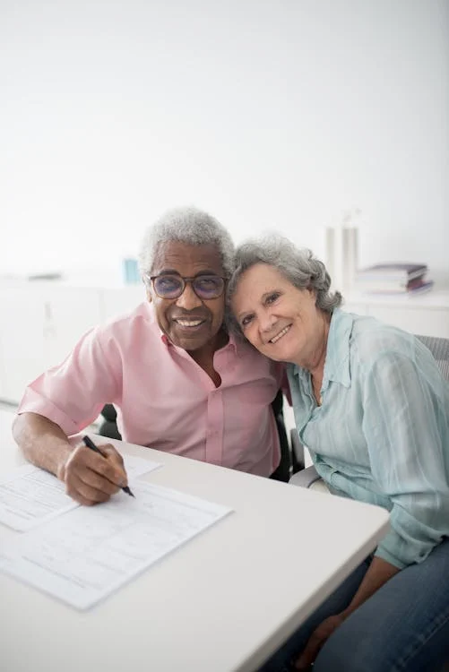 A man and a woman signing documents