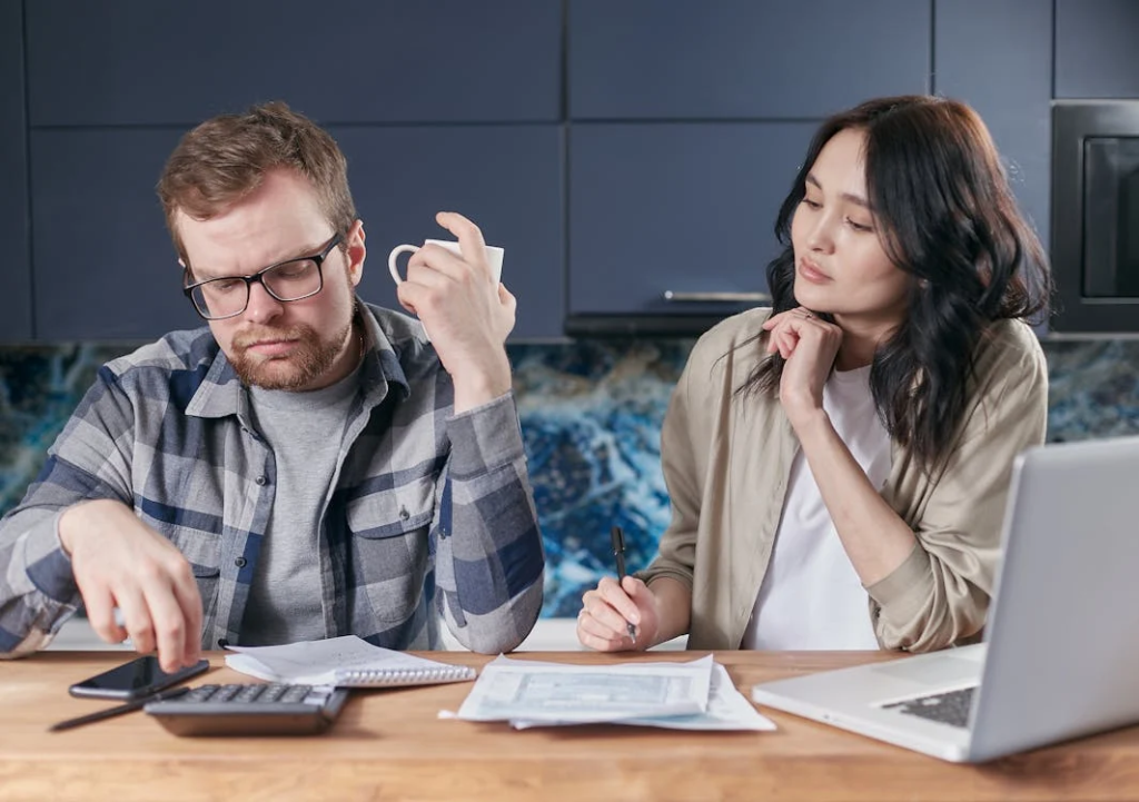 A man and a woman calculating costs