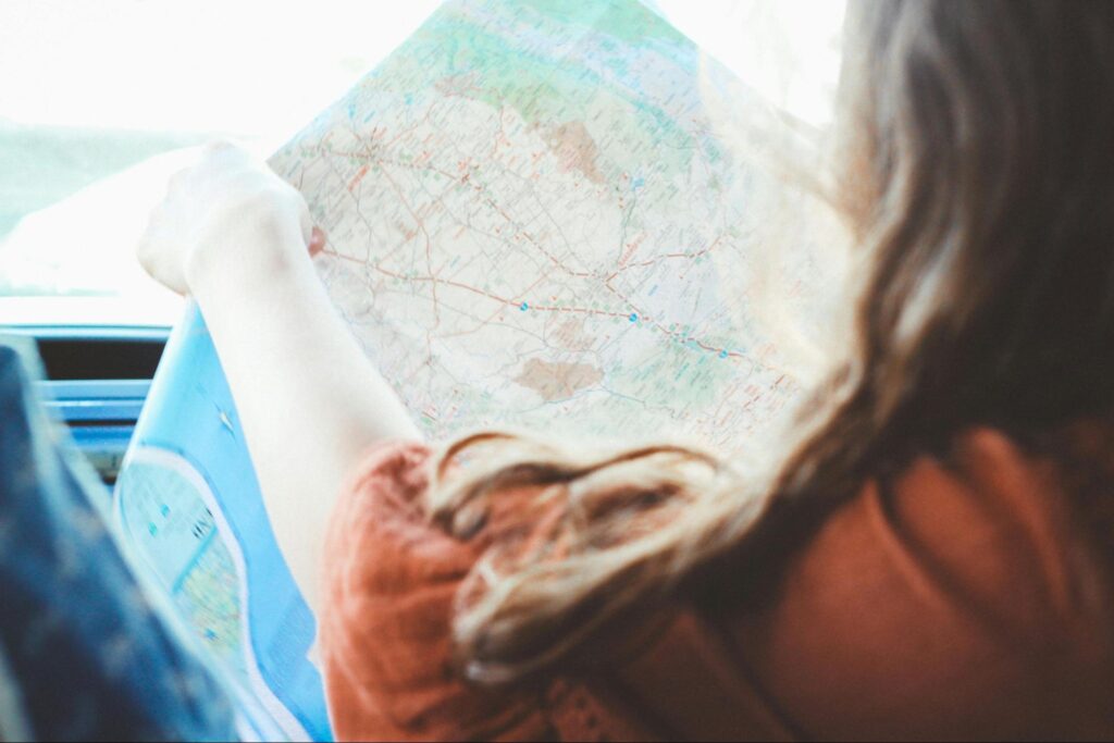 Woman on roadtrip looking at map