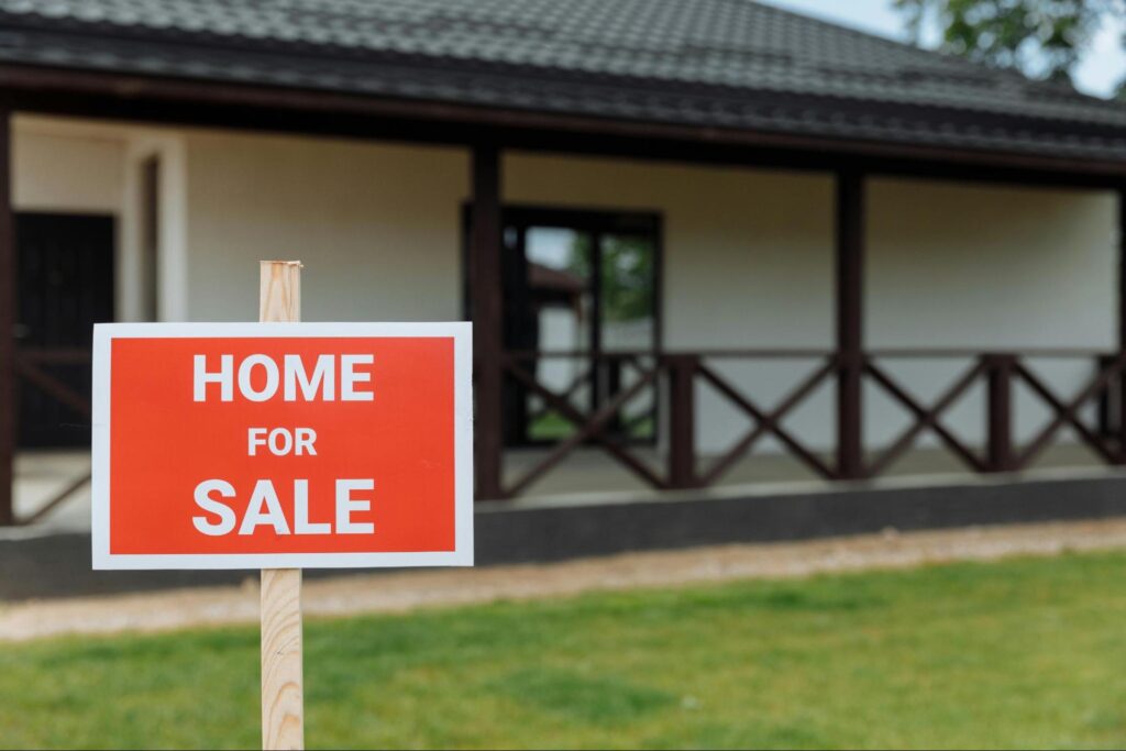 Home with a for sale sign in the yard