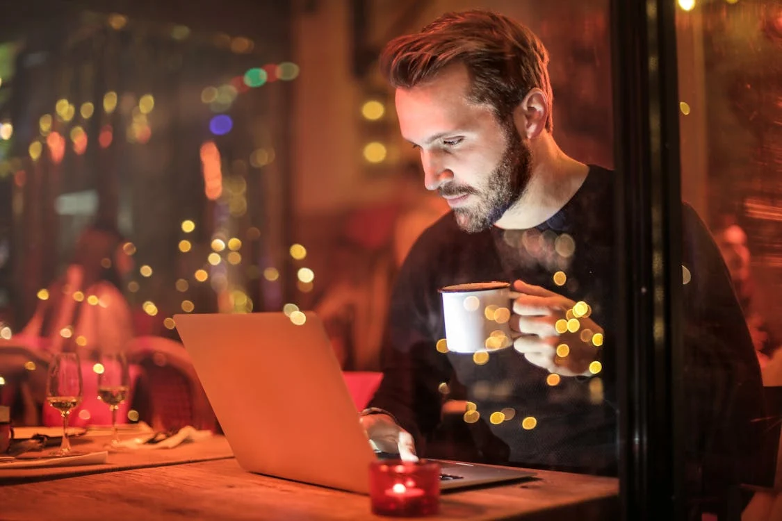 A man holding a mug and doing research