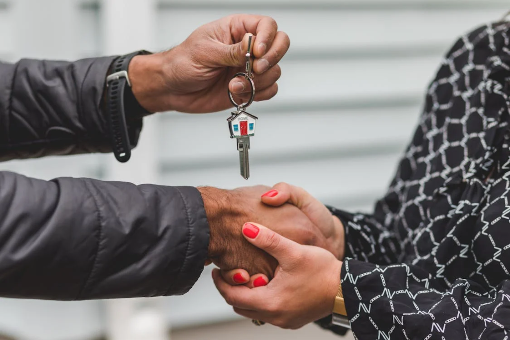 A person holding a silver key