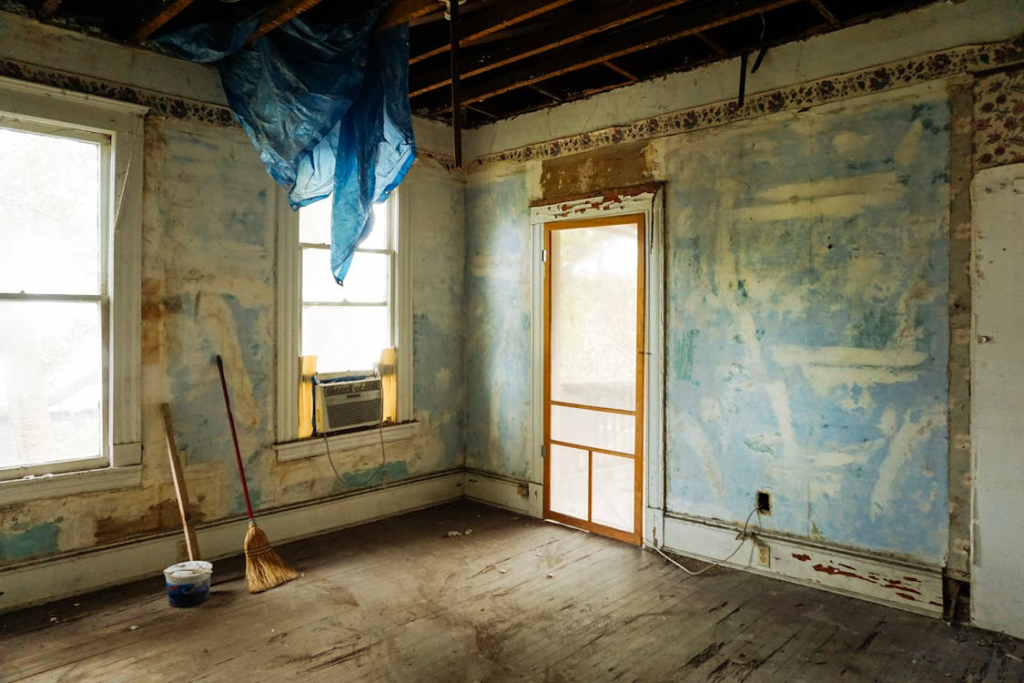 A broom and a mop bucket in a fixer-upper house