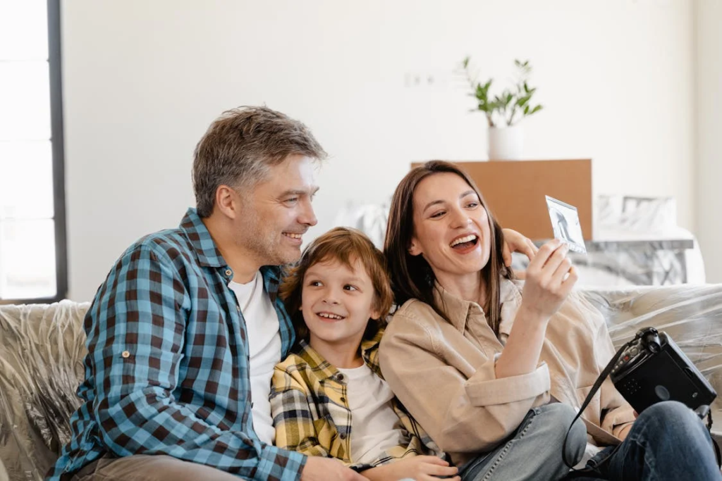 A family smiling after purchasing a new home