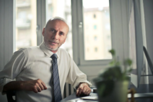 A man sitting on a chair at a desk