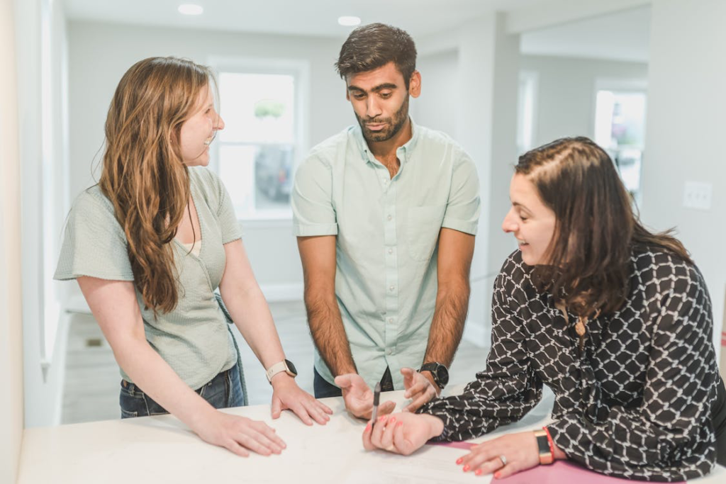 A couple speaking with a real estate agent 