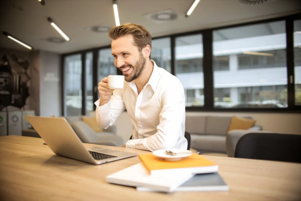 A man sitting at a desk with a laptop open