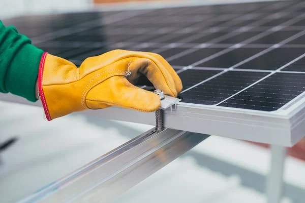 A hand on a solar panel