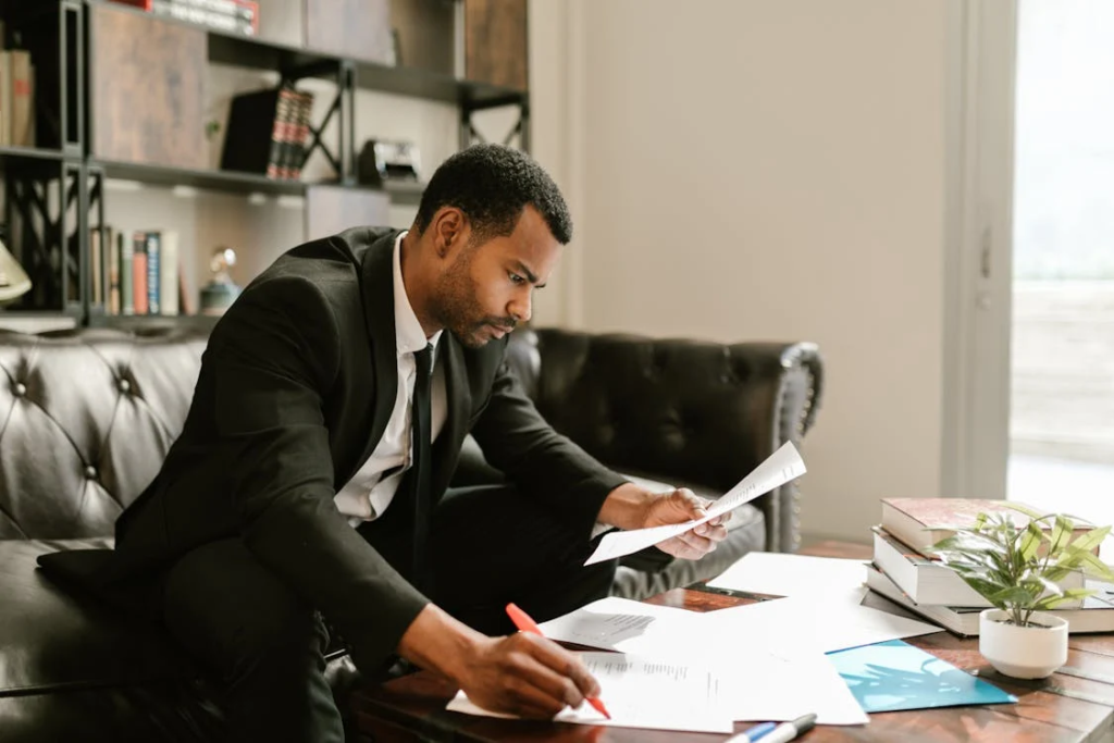 A man in a suit looking over documents