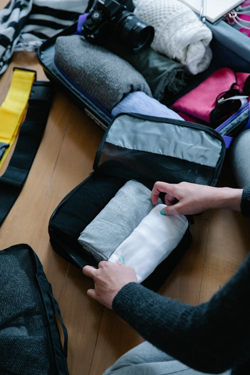 A person packing a suitcase