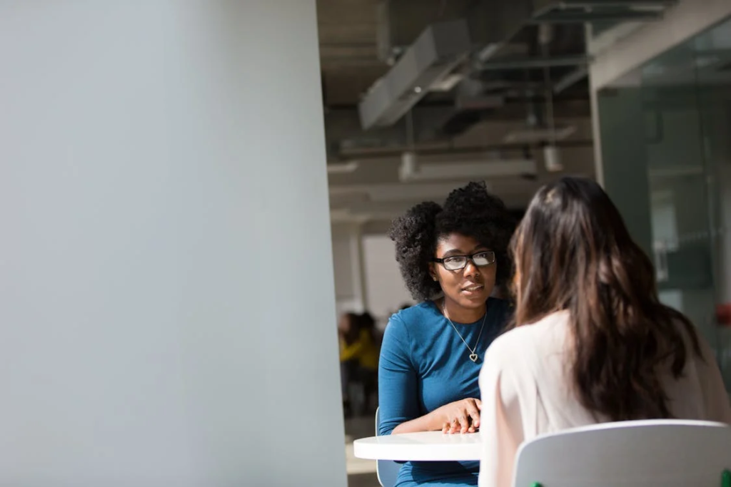 Two people having a conversation at a table